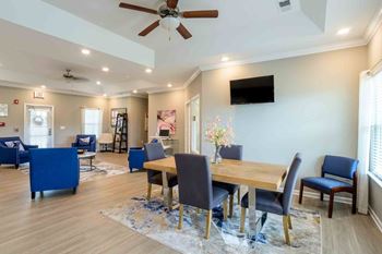 Dining room with a wooden table and blue chairs.